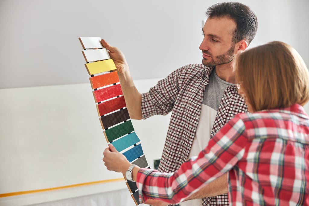 A worker and home owner picking a color
