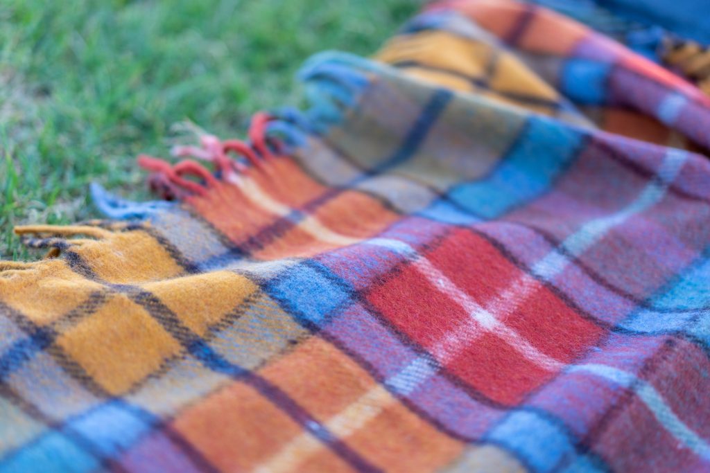 A blanket that lies on grass