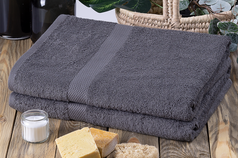 A grey hand towel on a wooden table