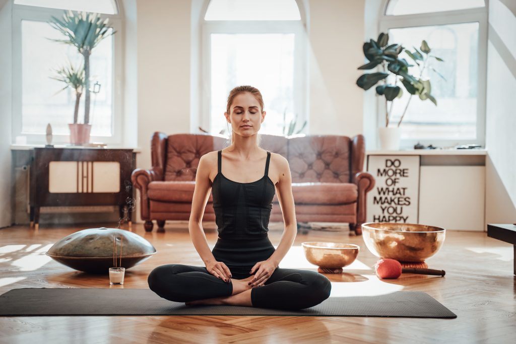 A woman doing yoga in her living room
